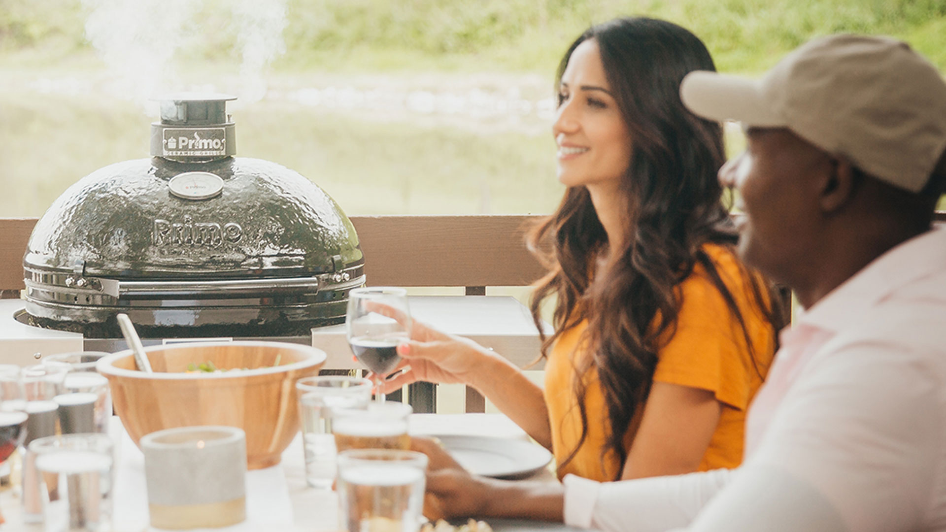 Primo grills round charcoal grill at dinner table